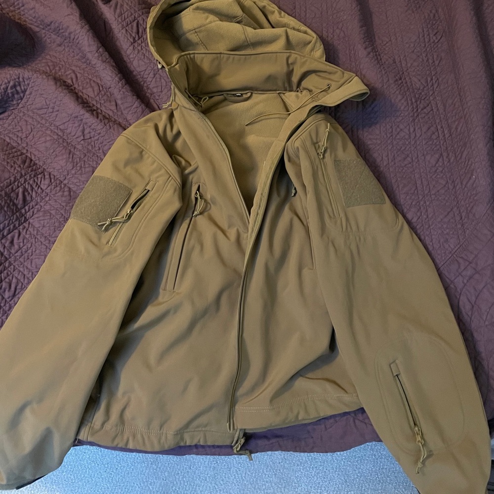Tactical coat with fold up hood.